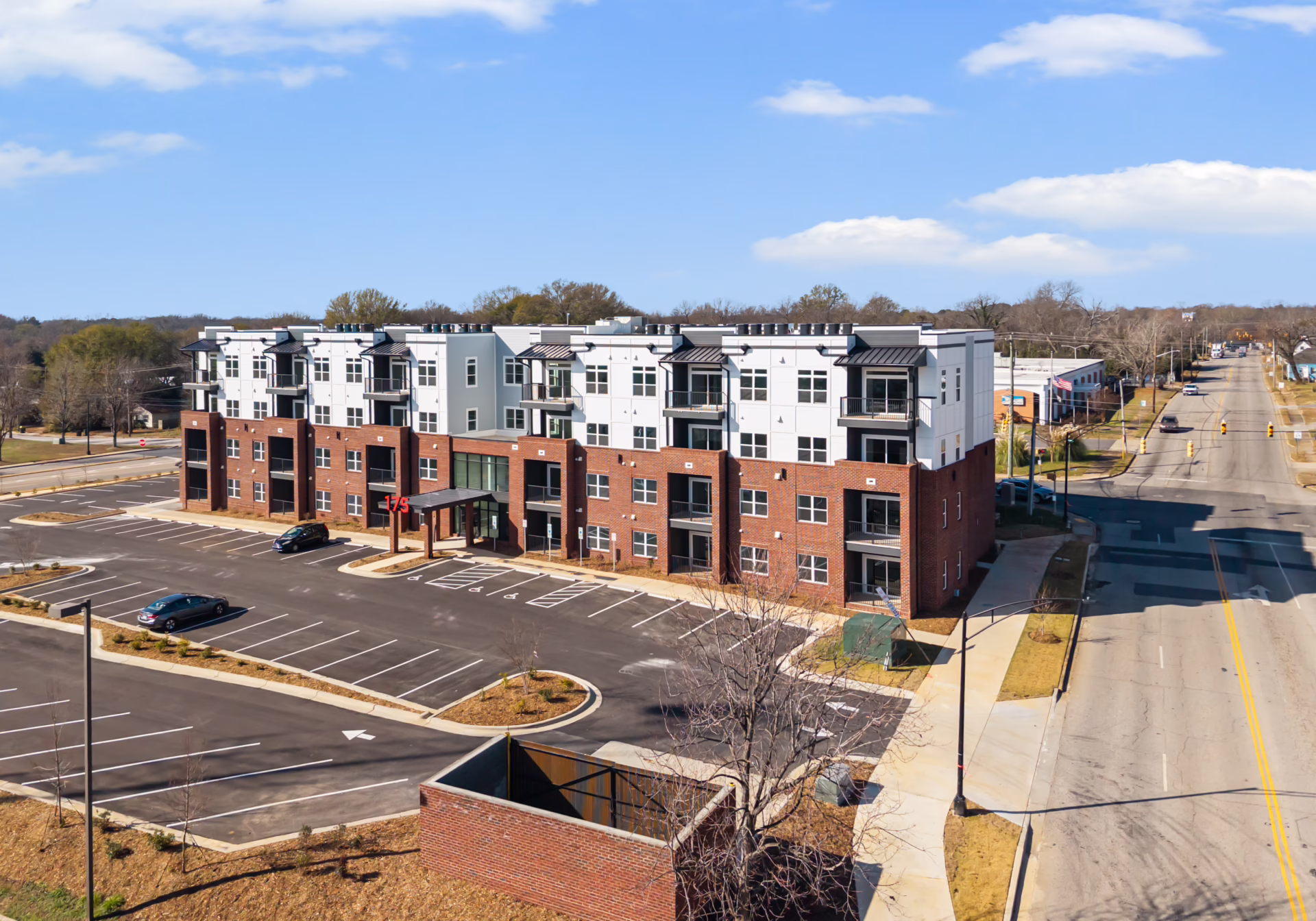 An aerial view along West Black Street showing Brixton Apartments on the corner and the street running north into downtown Rock Hill.