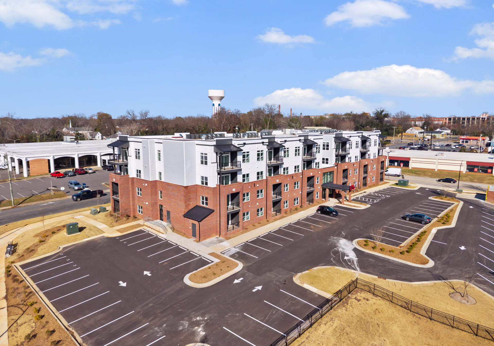 Aerial view of Brixton Apartments with the Rock Hill water tower and downtown beyond.
